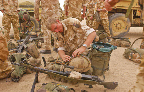 A 3 Para GPMG gunner checks through his belted ammunition for any dodgy links - photo 12