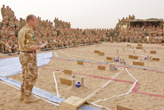 Lt Col Lorimer briefs the battalion on the overall plan using the model - photo 9