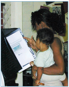 A woman with her child uses an electronic voting system to exercise her right - photo 4