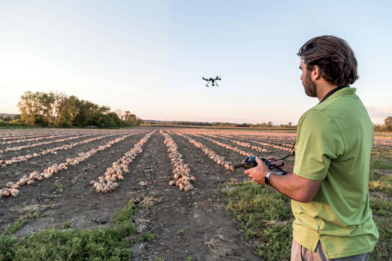 A man inspects his onion crop with a Typhoon Q500 drone FACT In the United - photo 5