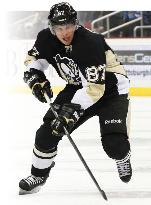 Number 87 Sidney Crosby takes his stick to the puck on the Penguins home ice - photo 3