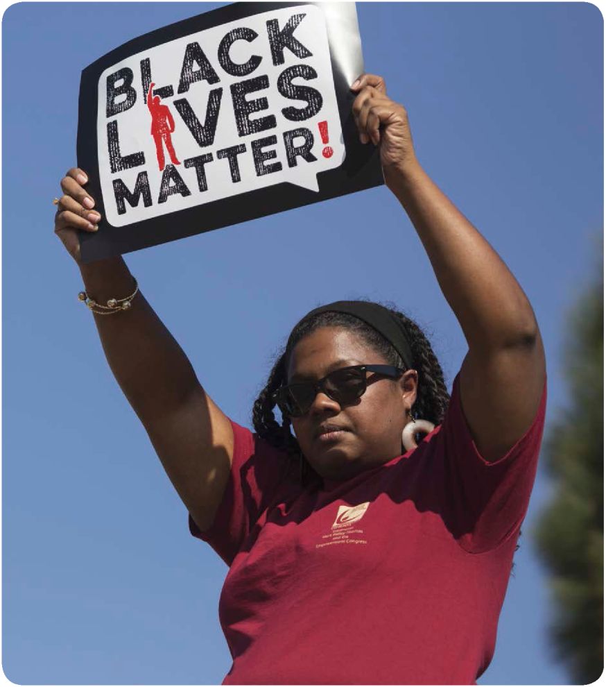 A woman holds a Black Lives Matter sign at a MLK Jr Day event in Los Angeles - photo 4