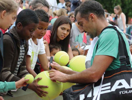 Professional tennis player Nenad Zimonjic signs autographs for fans after - photo 8