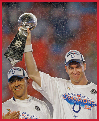 Head Coach Tony Dungy looks on as Manning raises the Lombardi Trophy after the - photo 5
