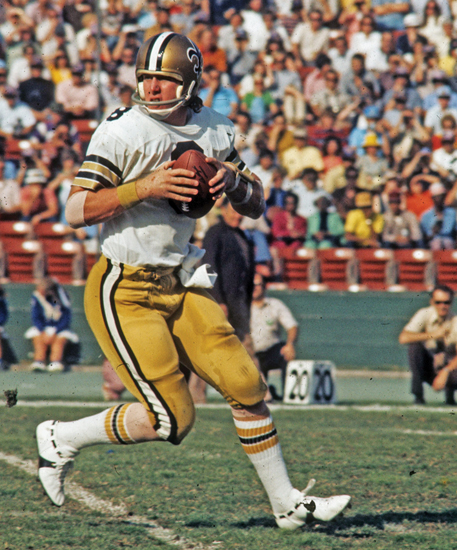 New Orleans Saints quarterback Archie Manning looks to make a pass during a - photo 6