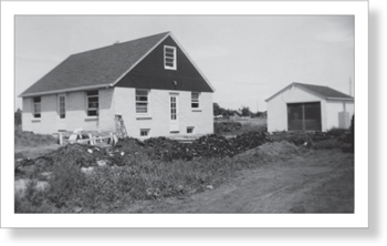 That tiny garage is where we lived while Dad finished building our second - photo 6