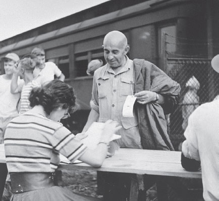 Refugees being checked in at the Fort Ontario Emergency Refugee Shelter by - photo 9