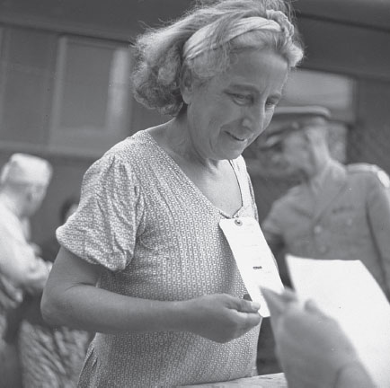 Refugee going through customs inspection The card around her neck was her only - photo 10