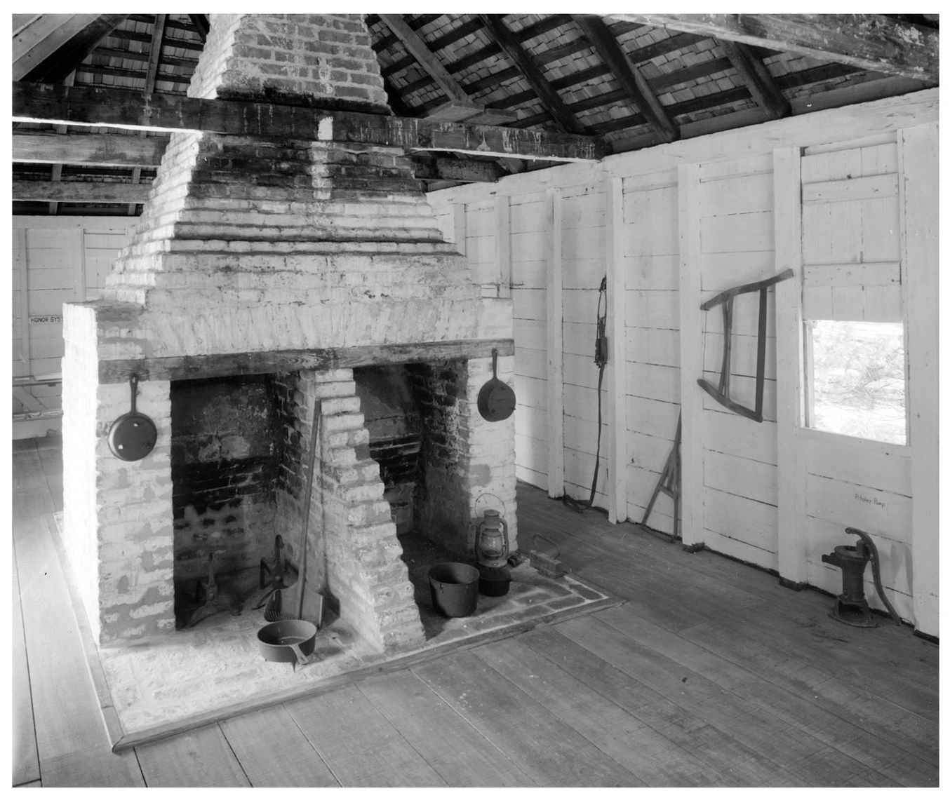 The thatched-roof interior and double fireplace of this slave cabin shows how - photo 2