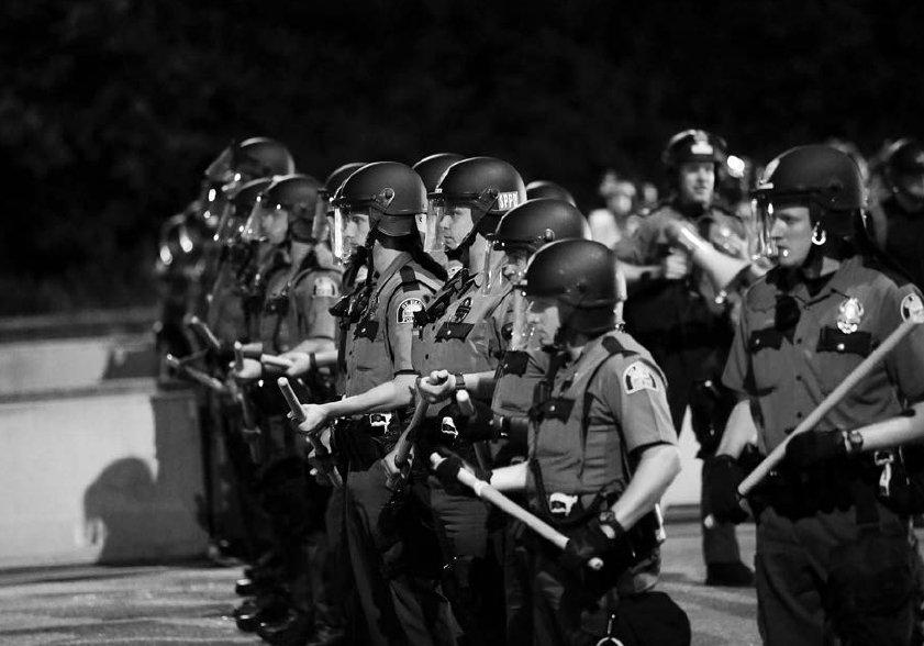 JOSHUA LOTT FOR THE NEW YORK TIMES Police officers watch demonstrators block - photo 2