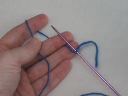 Wrap the yarn around your fingers as shown Bring the tip of the DPN up - photo 10