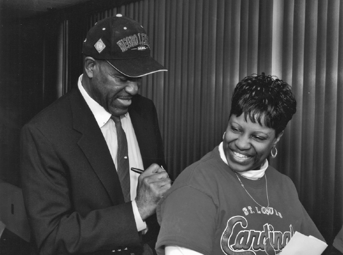 George Altman signing an autograph at a Negro Leagues Museum function in Kansas - photo 3