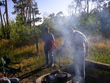 This is my wife and I at our family cabincooking in the Dutch oven over an open - photo 2