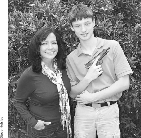 Karim Baker and son Hayden holding his GSG-1 911 22 pistol note - photo 7