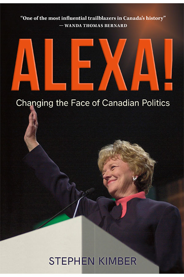 A photo of Alexa McDonough standing behind a light grey podium that has a - photo 1