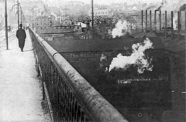 A solitary individual walks across the smoky Market Street Viaduct circa early - photo 4