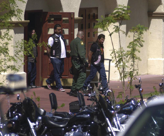 A police officer arrests two members of a motorcycle gang after a fight broke - photo 2