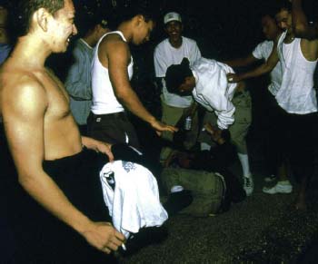 Boys who want to be part of a gang beat up a boy on the street as part of an - photo 4