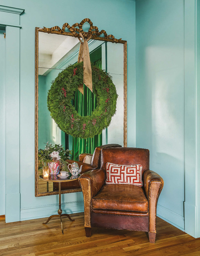 A massive wreath hung from an antique mirror by a silk sash provides an elegant - photo 18