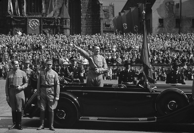 Rudolf Hess stands next to SA commander Viktor Lutze as Hitler takes the salute - photo 3