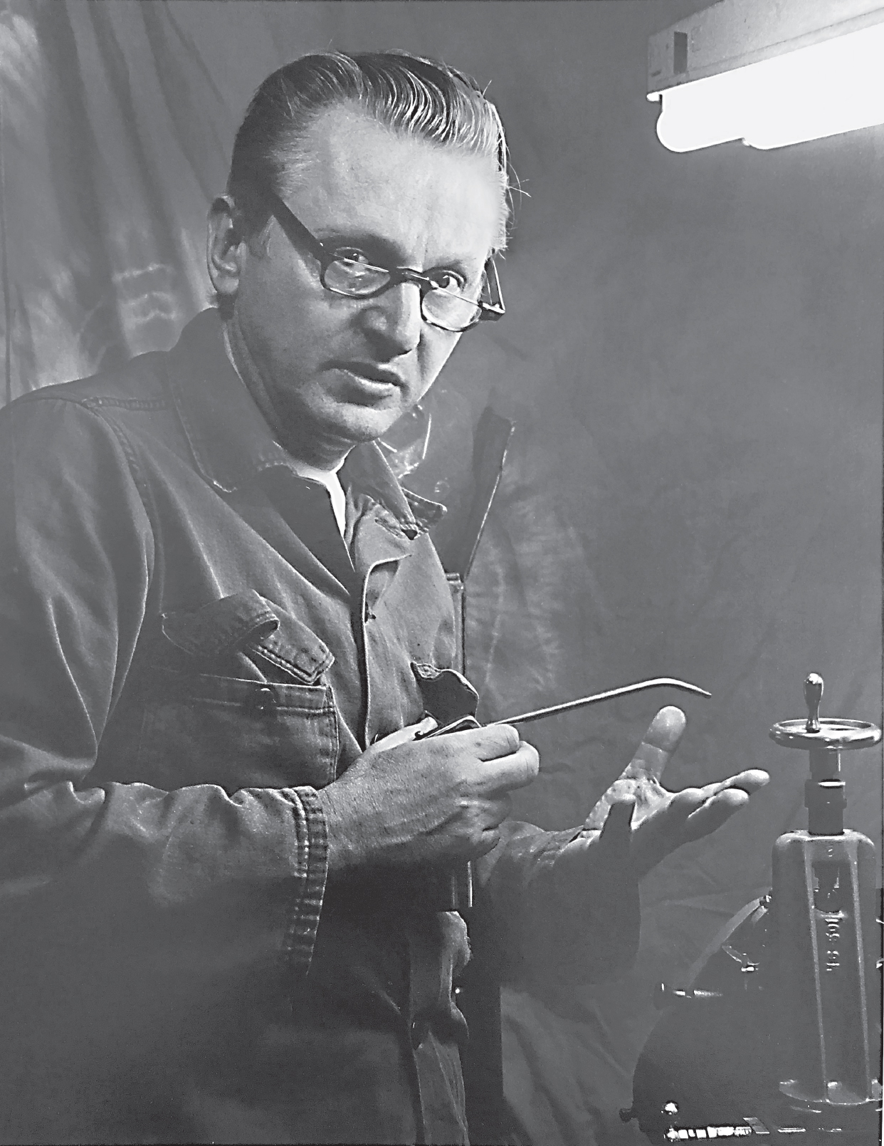 Robert M Pirsig oiling the lathe in his workshop 1975 Photograph by Bradley - photo 1