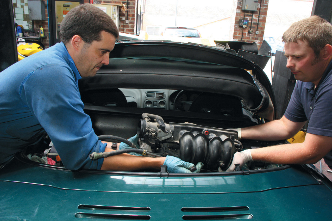 Co-author Rob Hawkins left gets stuck in pulling a K-series cylinder head - photo 5