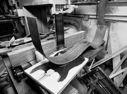 A Brazilian rosewood side after it has been bent sitting atop the Christies - photo 6