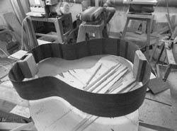 Rosewood guitar sides with the neck and tail blocks glued on Gluing the - photo 11