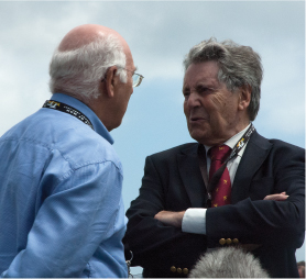 Murray Walker with Geoff Duke left and Carl Fogarty right chatting at the - photo 5