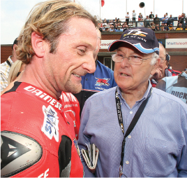 Murray Walker with Geoff Duke left and Carl Fogarty right chatting at the - photo 6