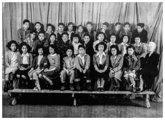 Classmates Bill Higuchi and Setsuko Saito sit next to each other in the center - photo 2