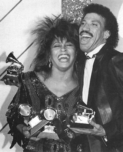 Tina Turner hugged by singersongwriter Lionel Ritchie holds the three - photo 2