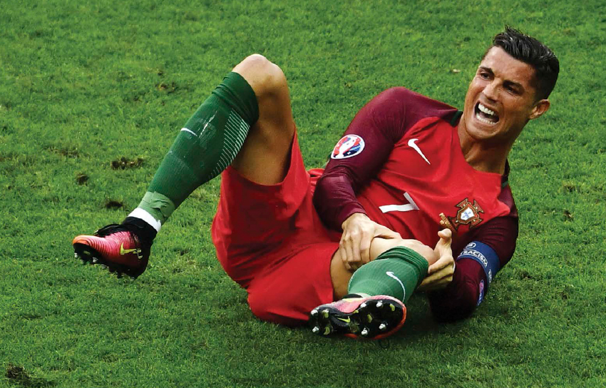 Cristiano Ronaldo grimaces in pain after injuring his knee during the 2016 Euro - photo 2