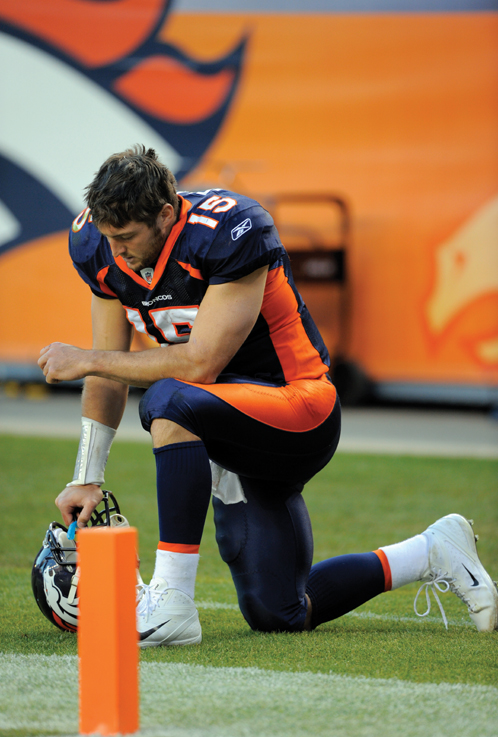 Image Credit AP ImagesJack Dempsey Tim Tebow kneels down and prays before the - photo 6