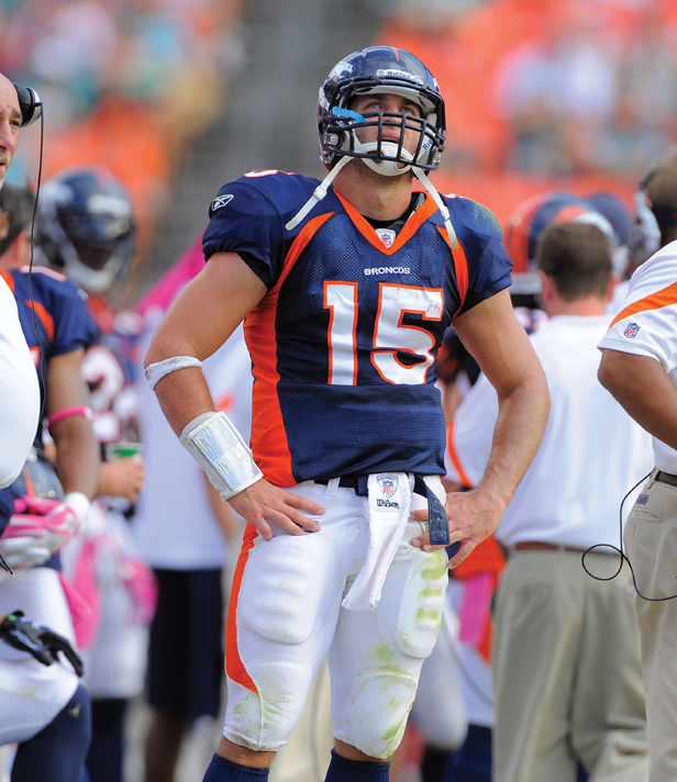 Image Credit AP ImagesScott A Miller Tim Tebow watches the scoreboard clock - photo 4