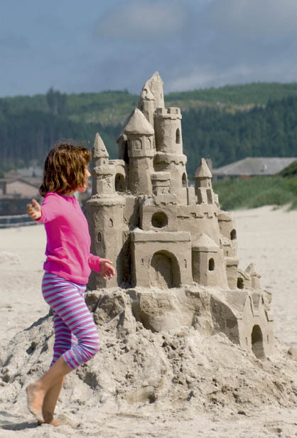 Girl dancing around a sand castle Cannon Beach Cape Blanco Lighthouse - photo 4