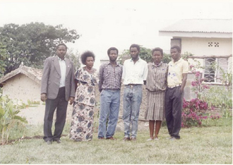 My family in front of our home From left Dad Mom Aimable Damascene me - photo 2