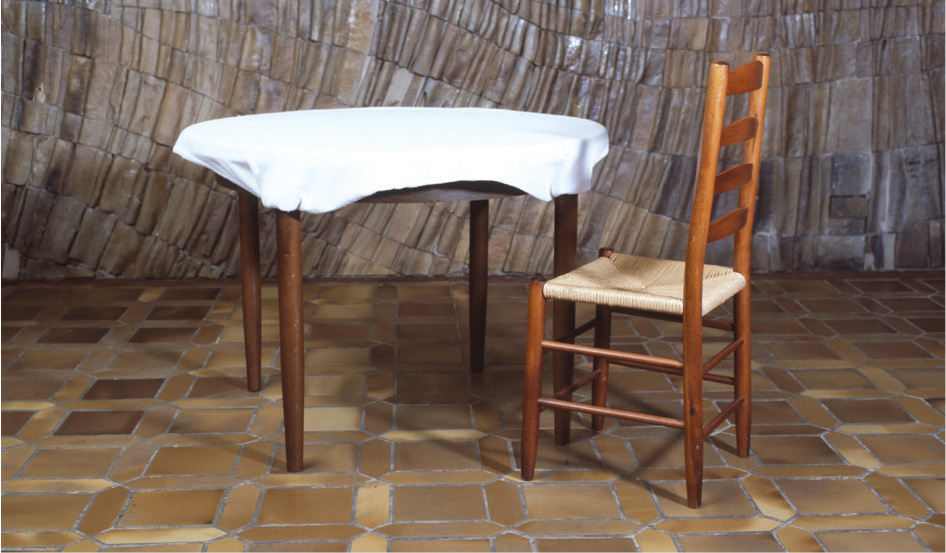 Round table lined with 5 seats Place a chair against one of the table legs to - photo 16