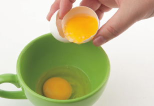 crack to gently split an eggshell to release the raw egg inside drain to - photo 16