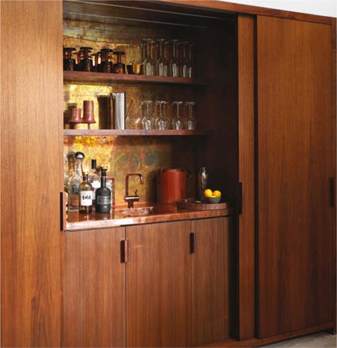 Featuring an aged brass panel and raw copper countertop the bar felt so right - photo 7