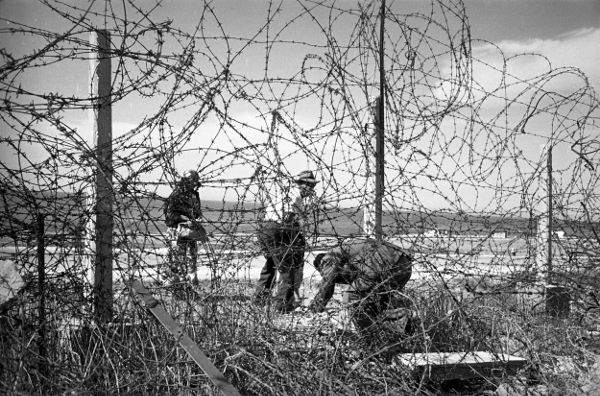 Figure 1 Crawling under the barbed wire fence Robert CapaMagnum Photos NOT - photo 2