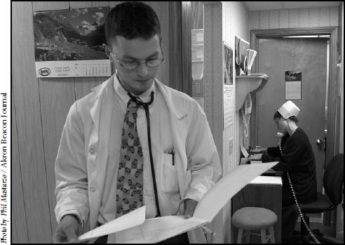 Dr Brent Lehman reviews a patients charts at the Mount Eaton Medical Center - photo 14