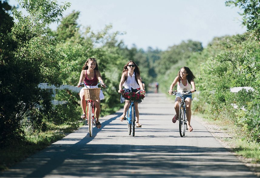 Teen girls pedal along the Shining Sea Bikeway in Falmouth Massachusetts - photo 3