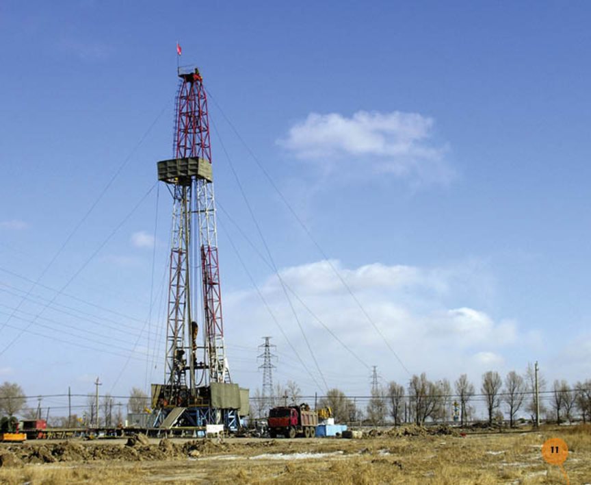 The drill digs for oil A worker runs the rigs drill The drill digs a deep - photo 11