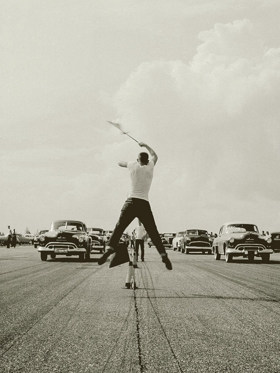 A man waves a flag to begin a drag race in the 1950s During World War II - photo 11