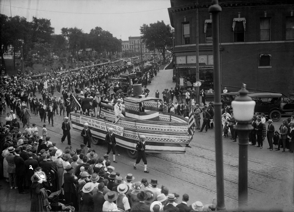 Part of a Labor Day parade featuring a float shaped like a boat turns off the - photo 5