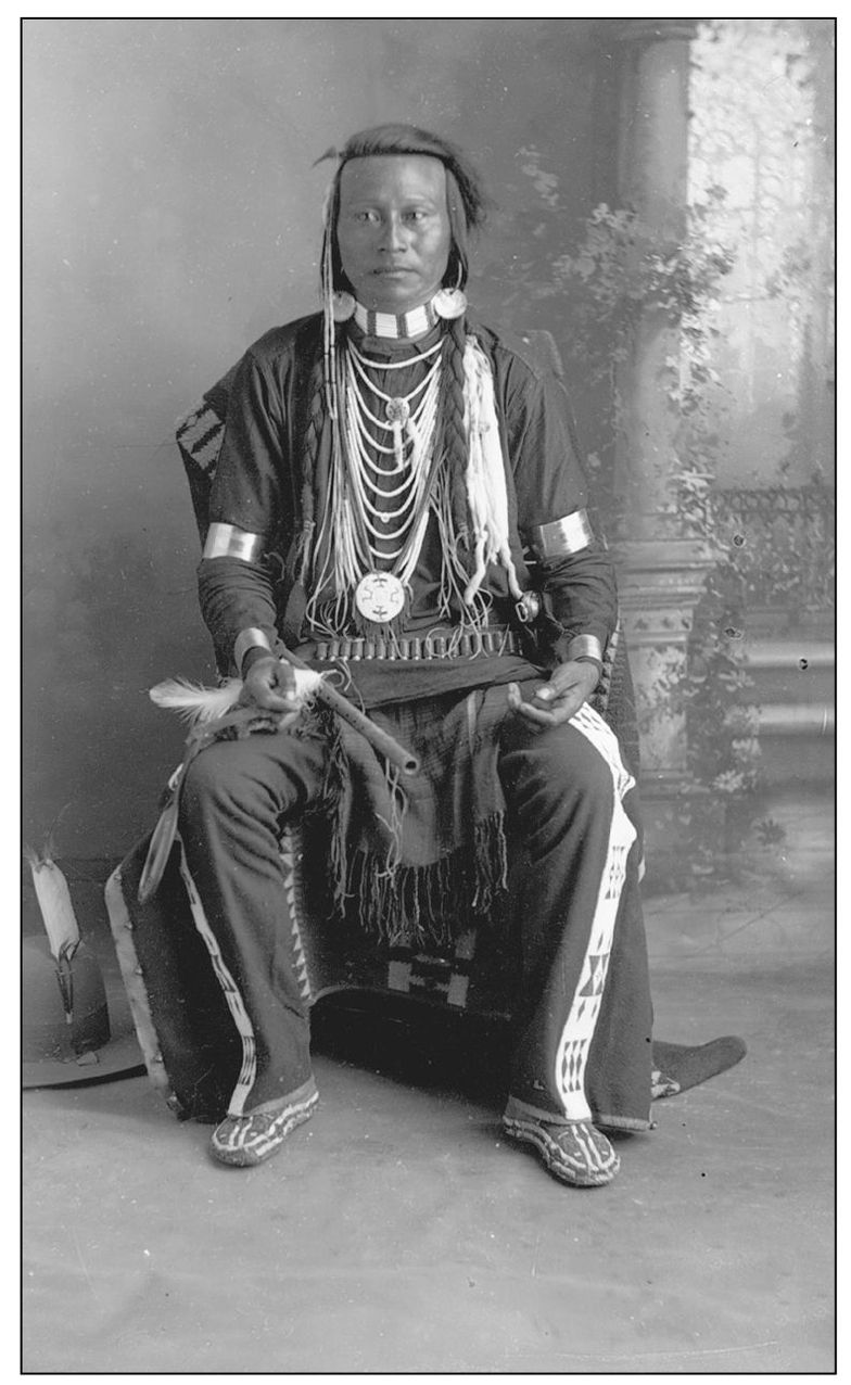 A Lemhi Shoshone man wears abalone-shell earrings He has a flute in his lap - photo 6
