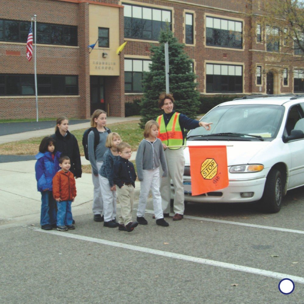 Children wait on the corner The crossing guard tells them when it is - photo 11