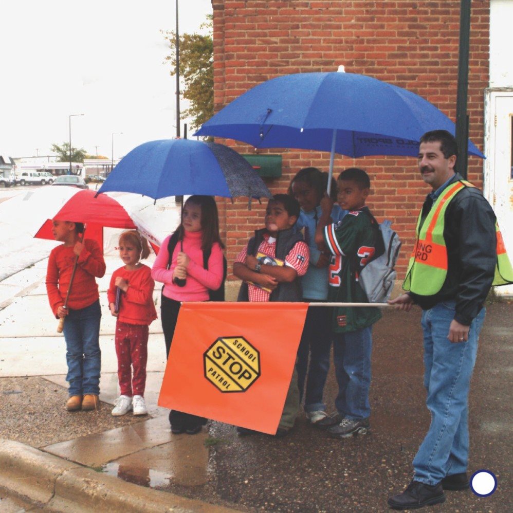 Sometimes a crossing guard walks with the children as they cross the - photo 13