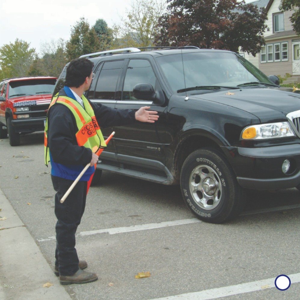 Crossing guards wear bright vests or coats The bright color helps - photo 17